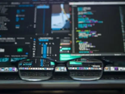 A pair of glasses in front of a screen showing an analytics dashboard